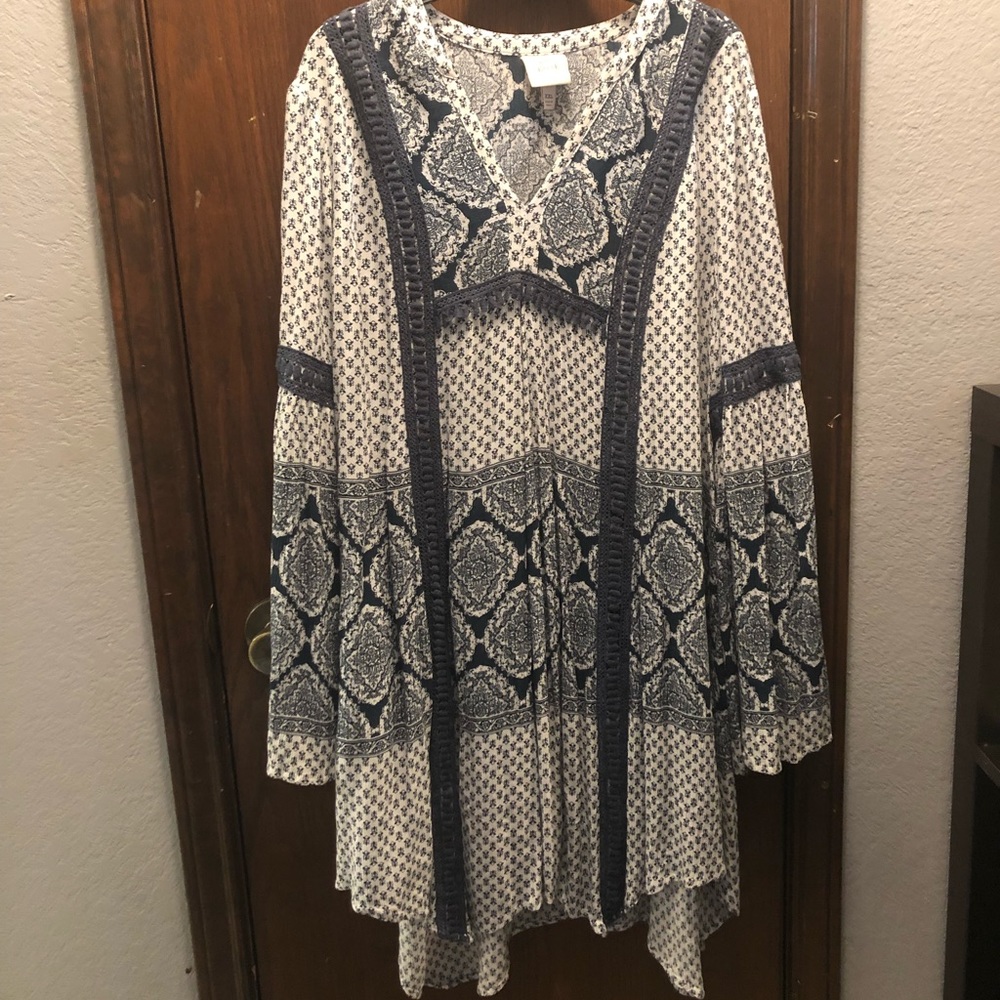 A blue and white flowy dress with flared sleeves.